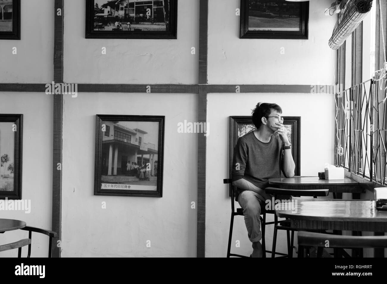 man alone in the cafe black and white Stock Photo