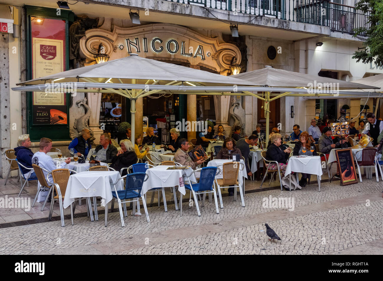 People sitting outside Café Nicola at the Rossio Square in Lisbon, Portugal Stock Photo