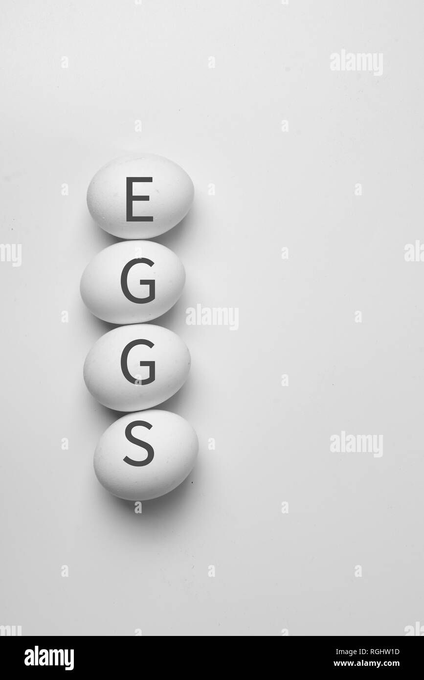 Minimalism style top view of four eggs white background farming organic natural concept Stock Photo