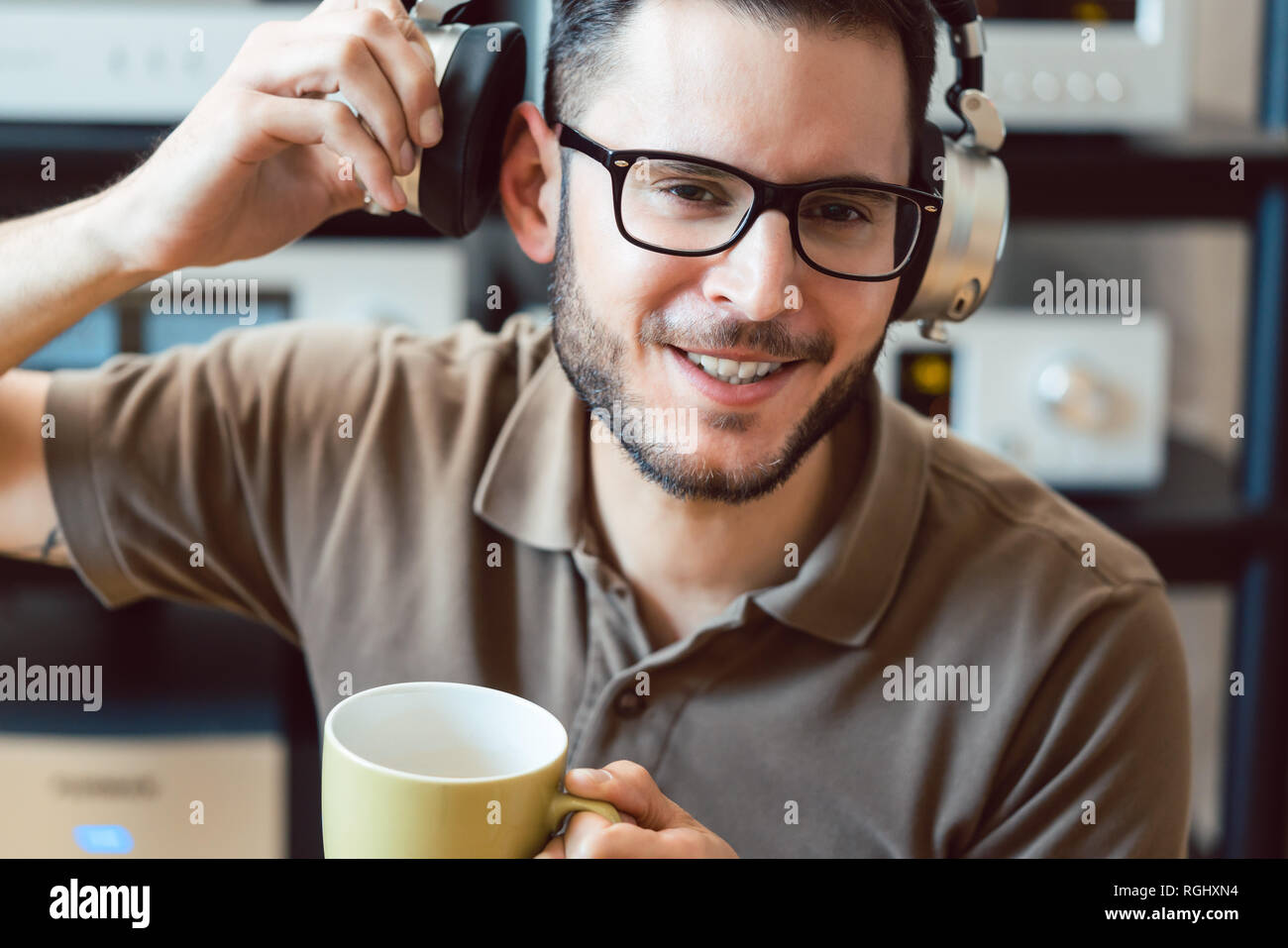 Man drinking coffee and listening to music Stock Photo