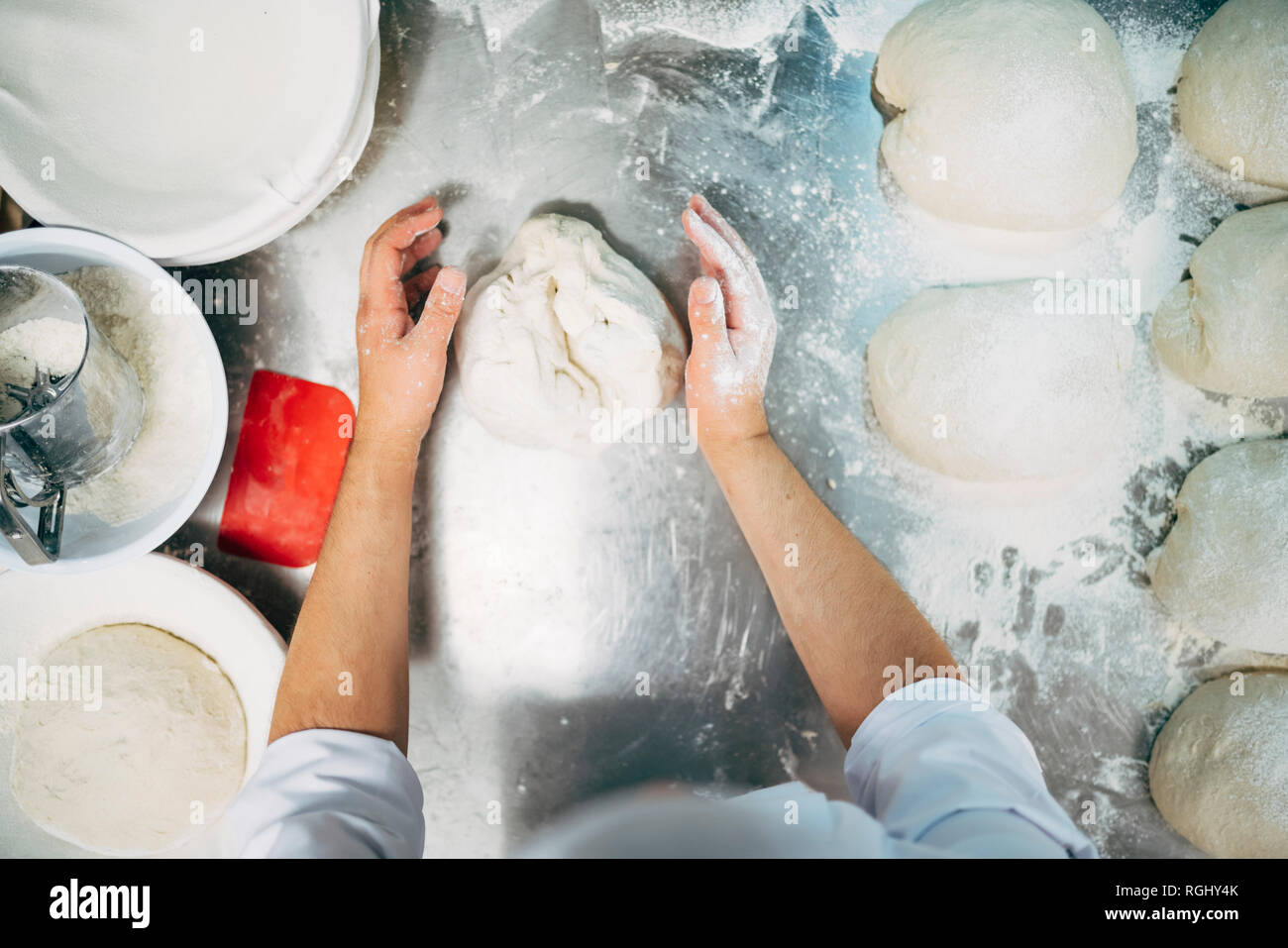 Baker working with dough in bakery Stock Photo