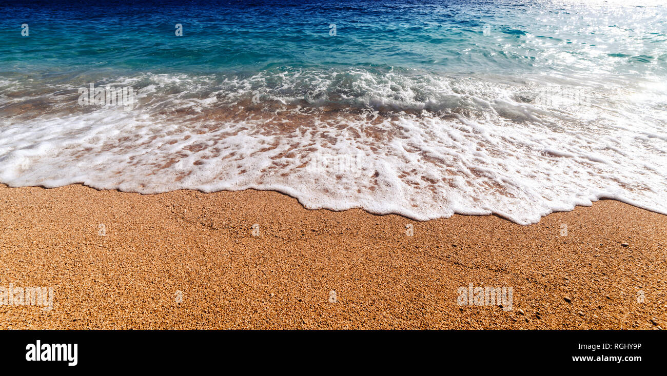 Amazing Mediterranean seascape with golden sand and blue waves. Summer vacations background Stock Photo