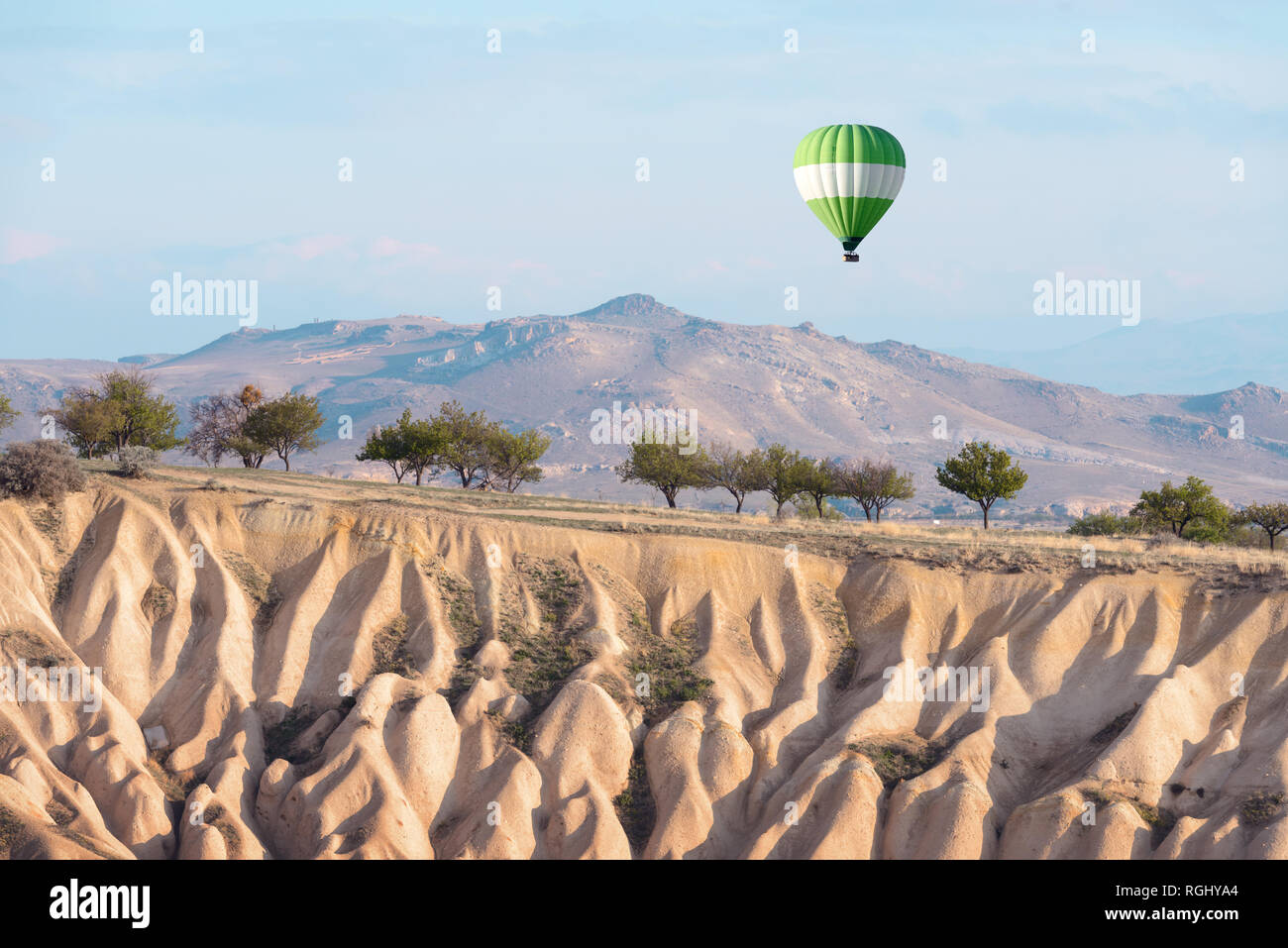 Green balloon in the sunrise sky. Cappadocia, Turkey. Landscape photography Stock Photo