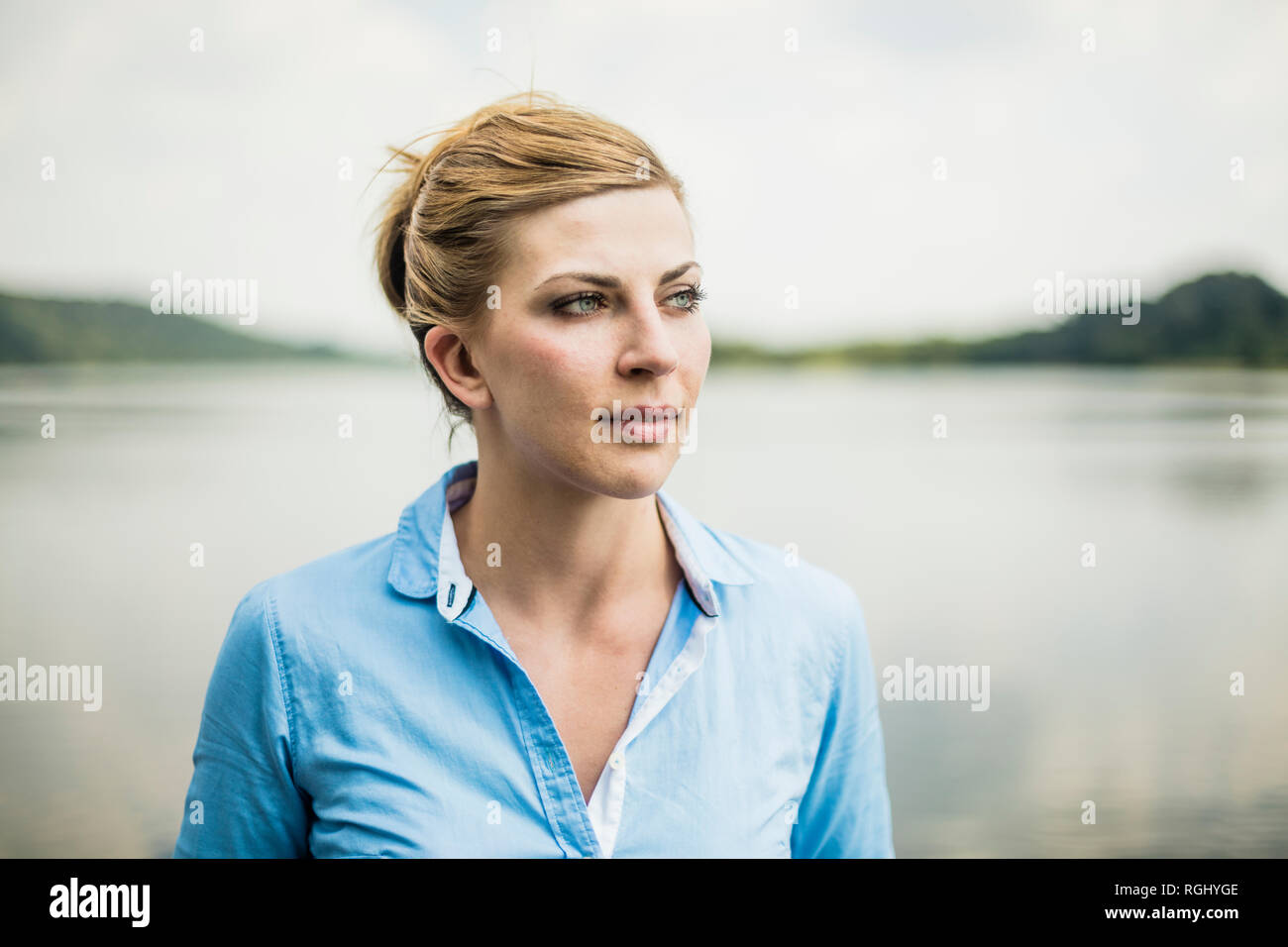 Portrait of woman at a lake looking sideways Stock Photo