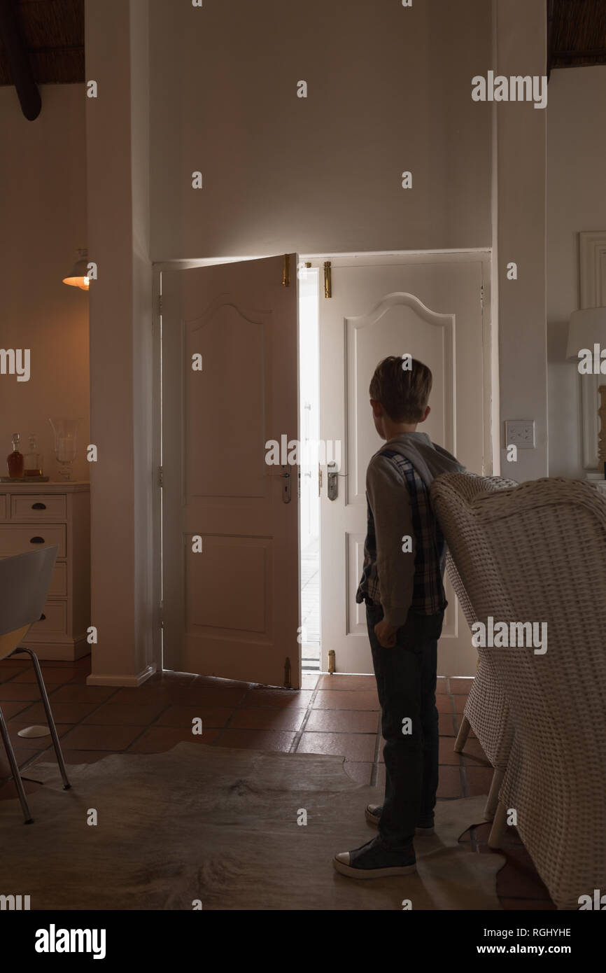 Boy standing and looking at door Stock Photo