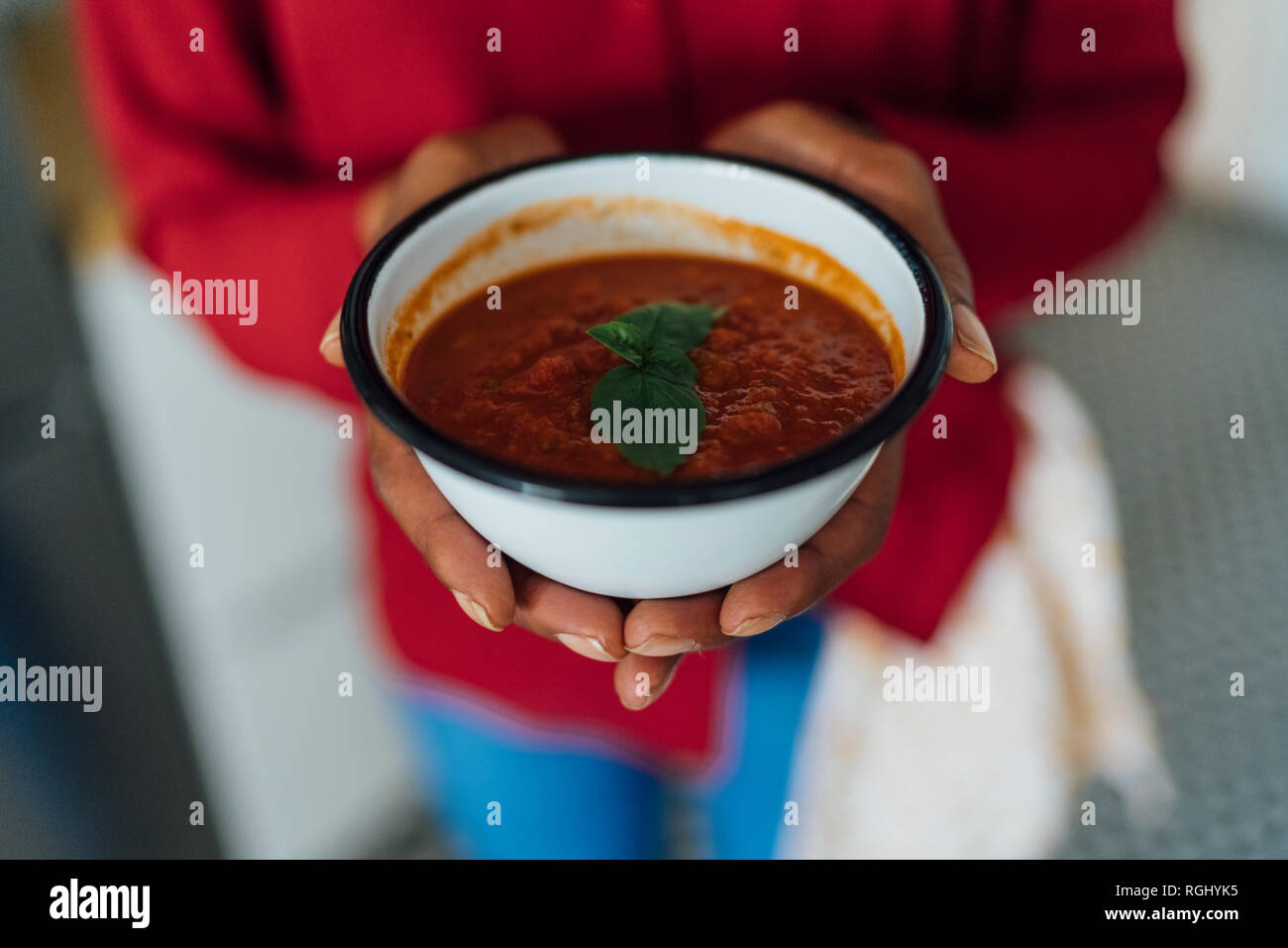 Woman holding bowl of gazpacho Stock Photo