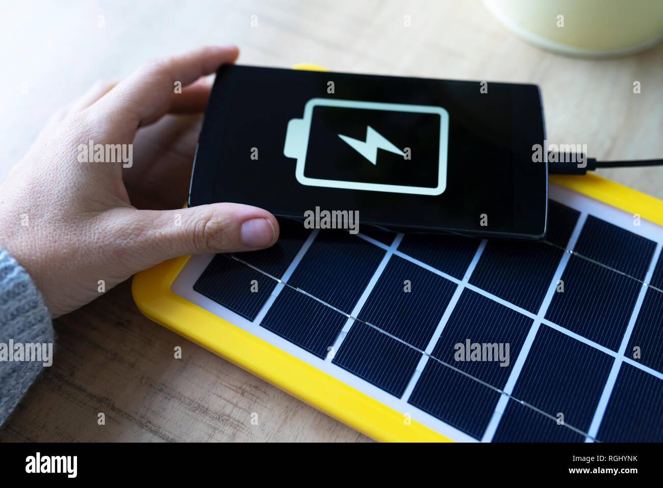 Renewable energy technology, solar panel charging a mobile phone battery Stock Photo