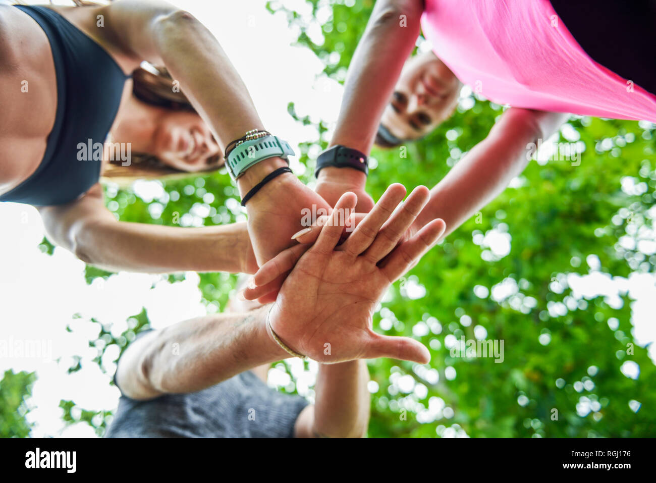 Young sports team stacking hands, celebrating success Stock Photo