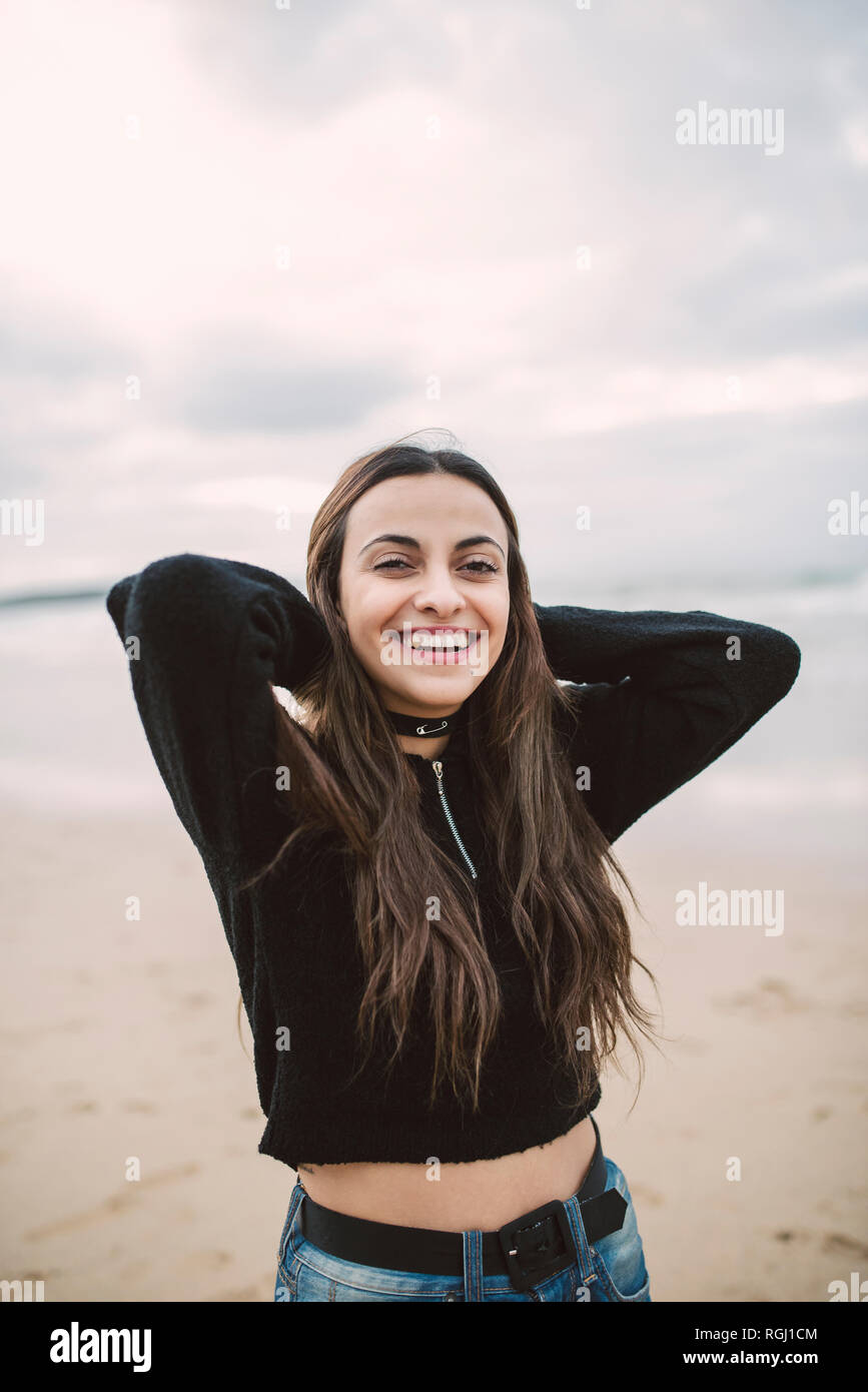 Portrait of happy young woman on the beach Stock Photo - Alamy