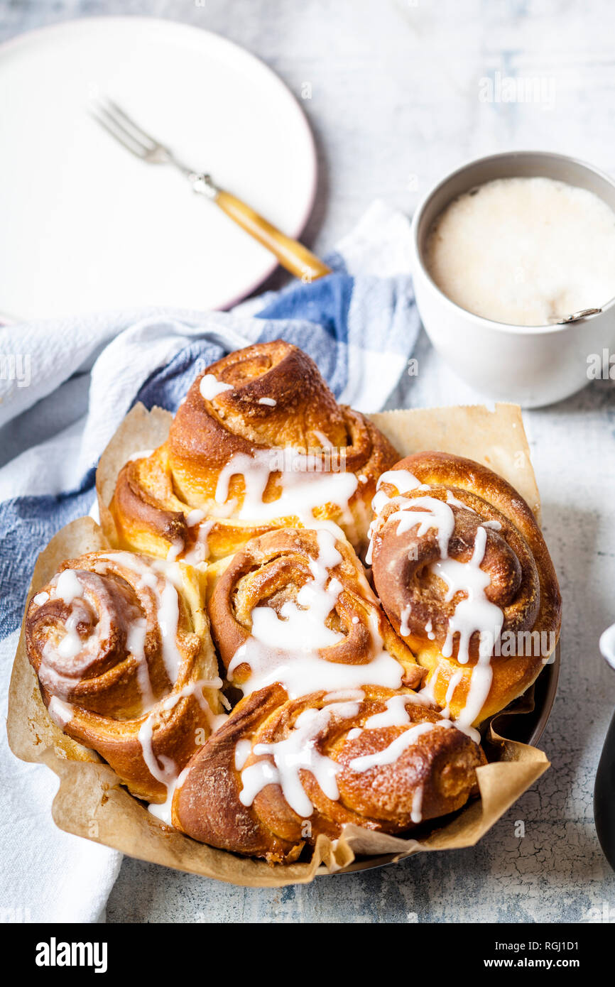 Tray of home-baked cinnamon buns with icing sugar Stock Photo