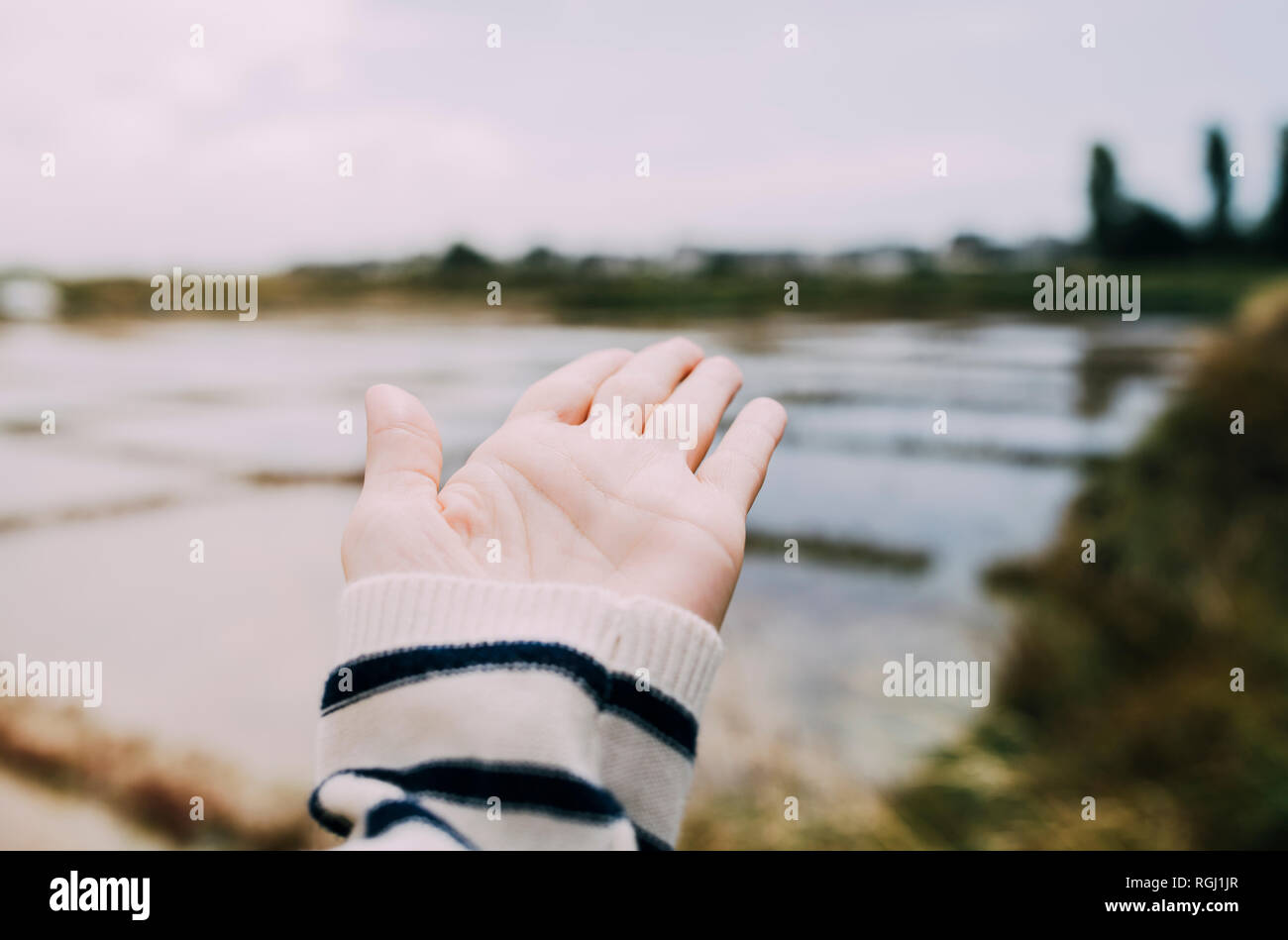 France, Bretagne, Guerande, hand showing to saline Stock Photo