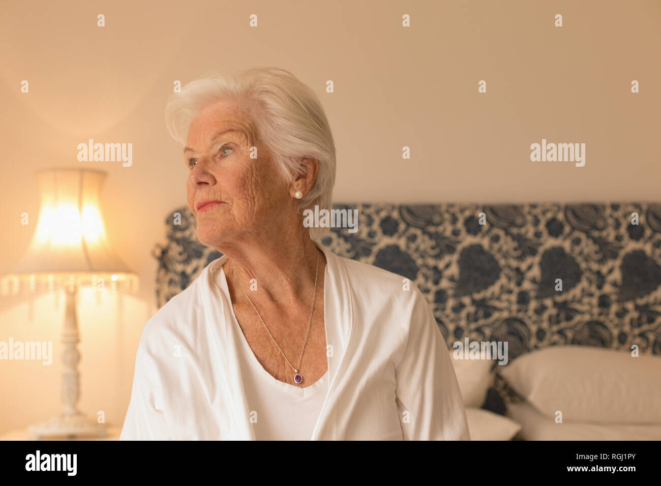 Senior woman relaxing in bedroom at home Stock Photo