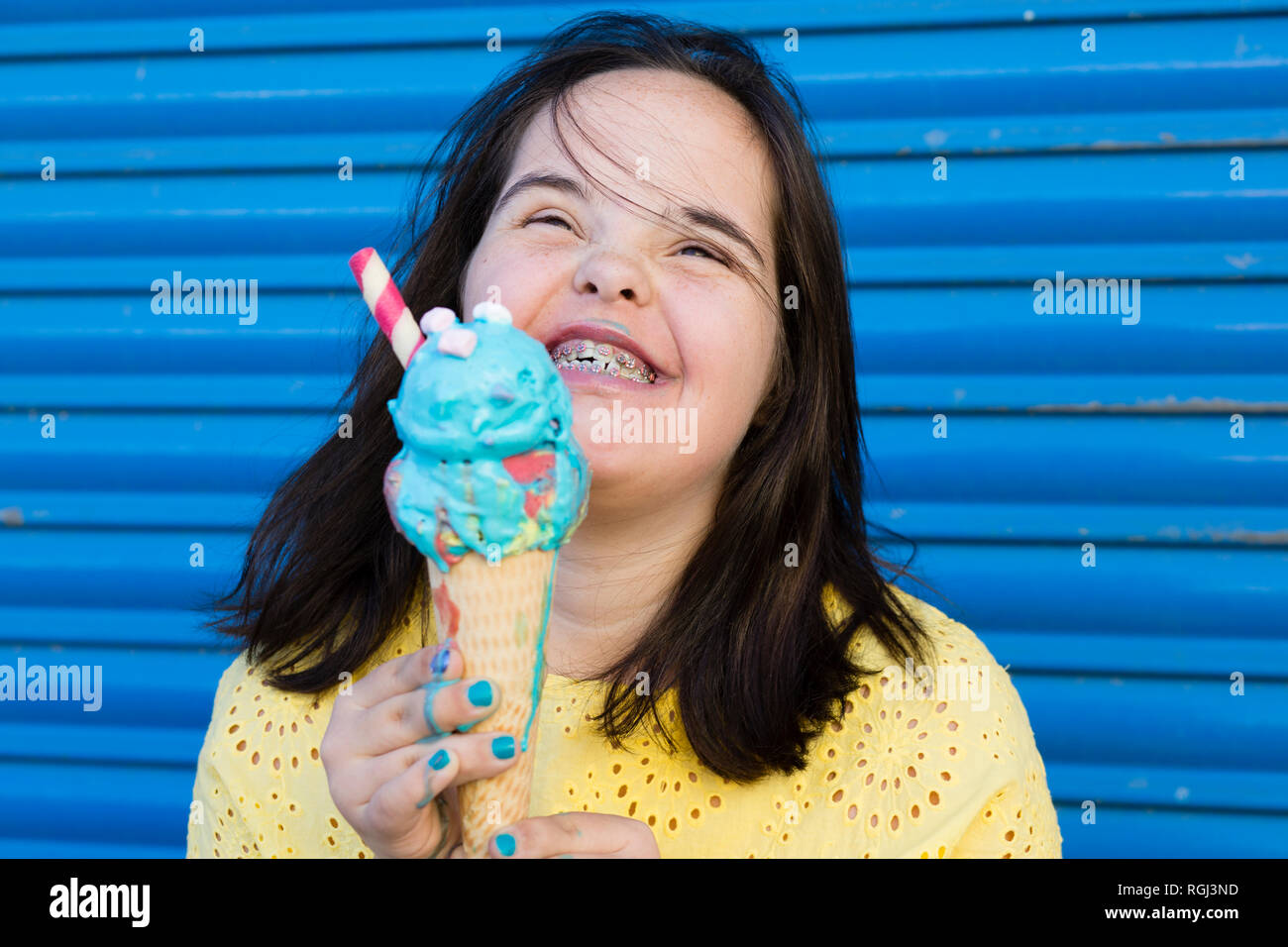 Teenager girl with down syndrome enjoying an ice cream Stock Photo