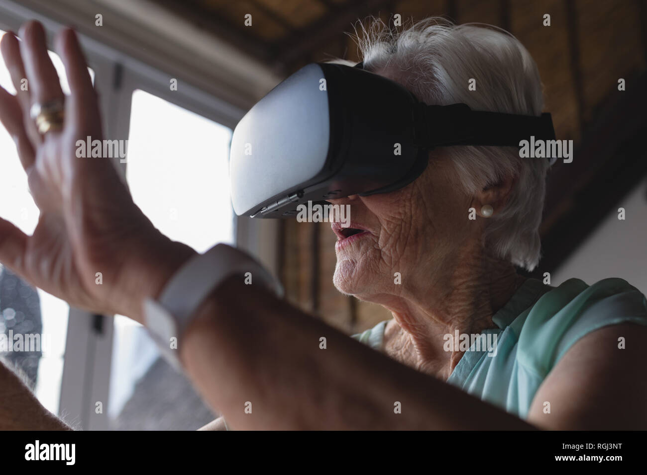 Senior woman using virtual reality headset Stock Photo Alamy