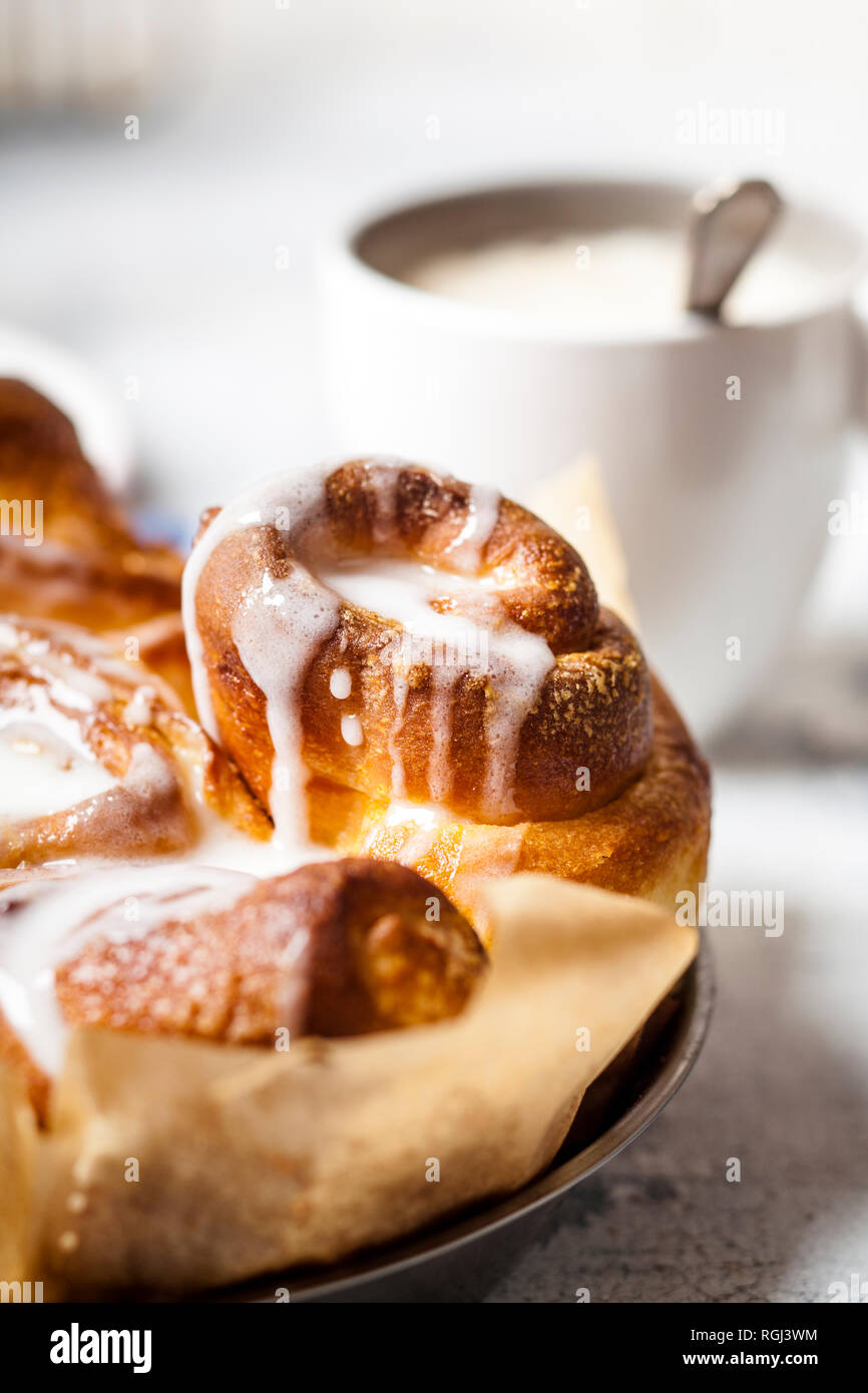 Home-baked cinnamon buns with icing sugar, close-up Stock Photo