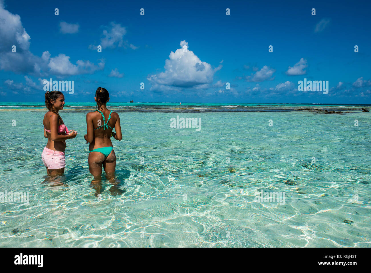 Carribean, Colombia, San Andres, El Acuario, two women standing in shallow turquoise water Stock Photo