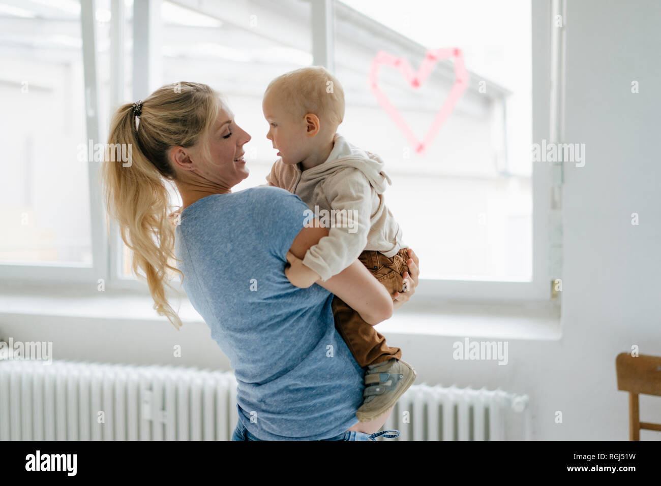 Happy pregnant mother carrying toddler son Stock Photo - Alamy