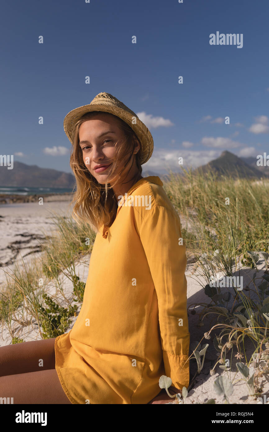 Woman in hat relaxing on the beach Stock Photo