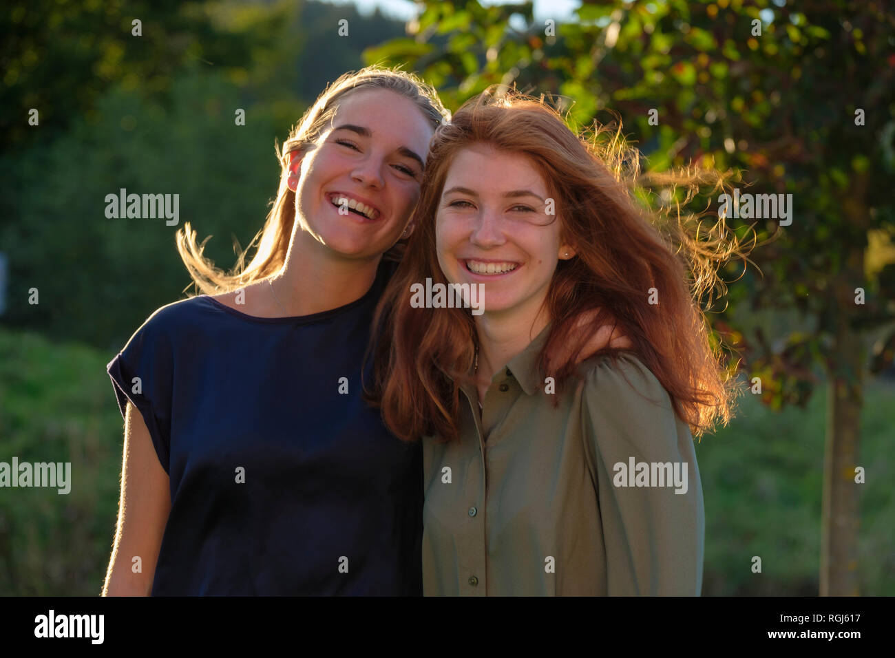 Portrait of two happy friends at evening twilight Stock Photo