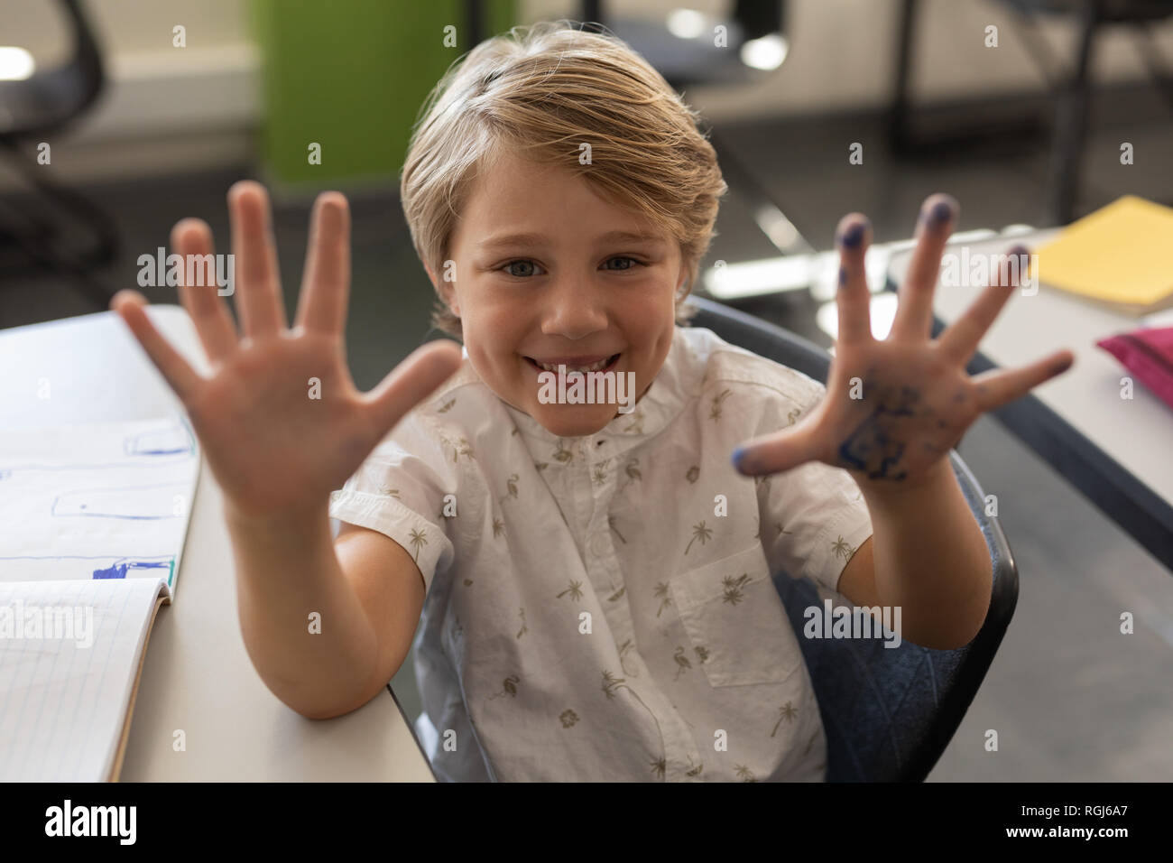 Schoolboy showing his dirty hands full of color Stock Photo