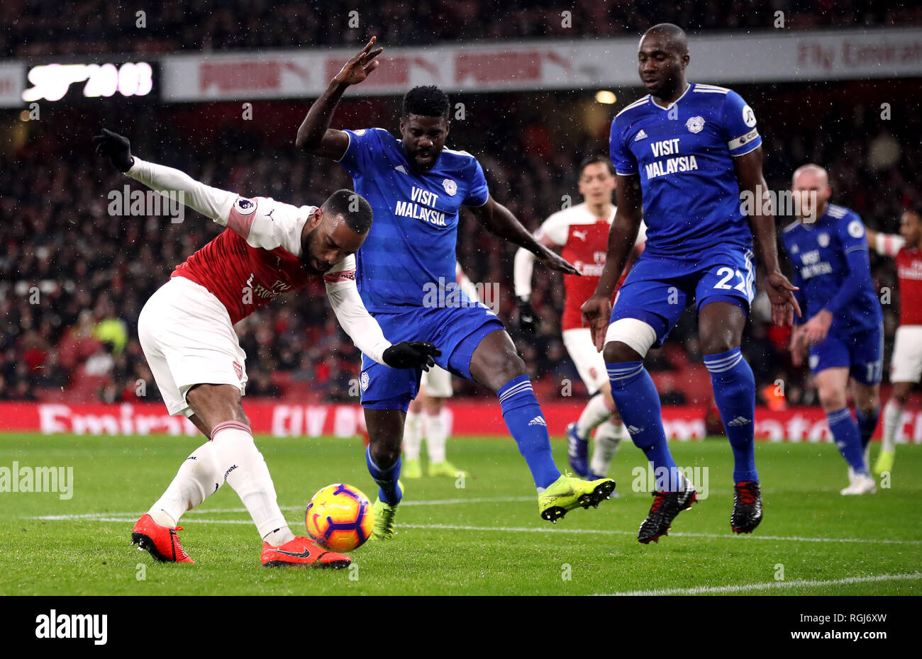 Arsenal's Alexandre Lacazette has a shot challenged by Cardiff City's Bruno Ecuele Manga during the Premier League match at the Emirates Stadium, London. Stock Photo