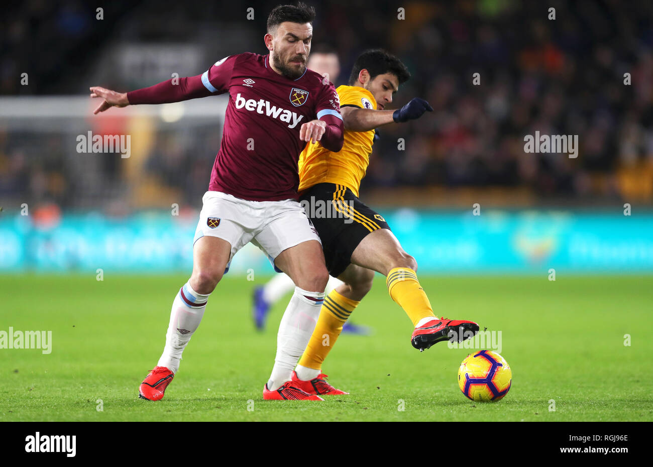 West Ham United's Robert Snodgrass (left) and Wolverhampton Wanderers' Raul Jimenez battle for the ball during the Premier League match at Molineux, Wolverhampton. Stock Photo