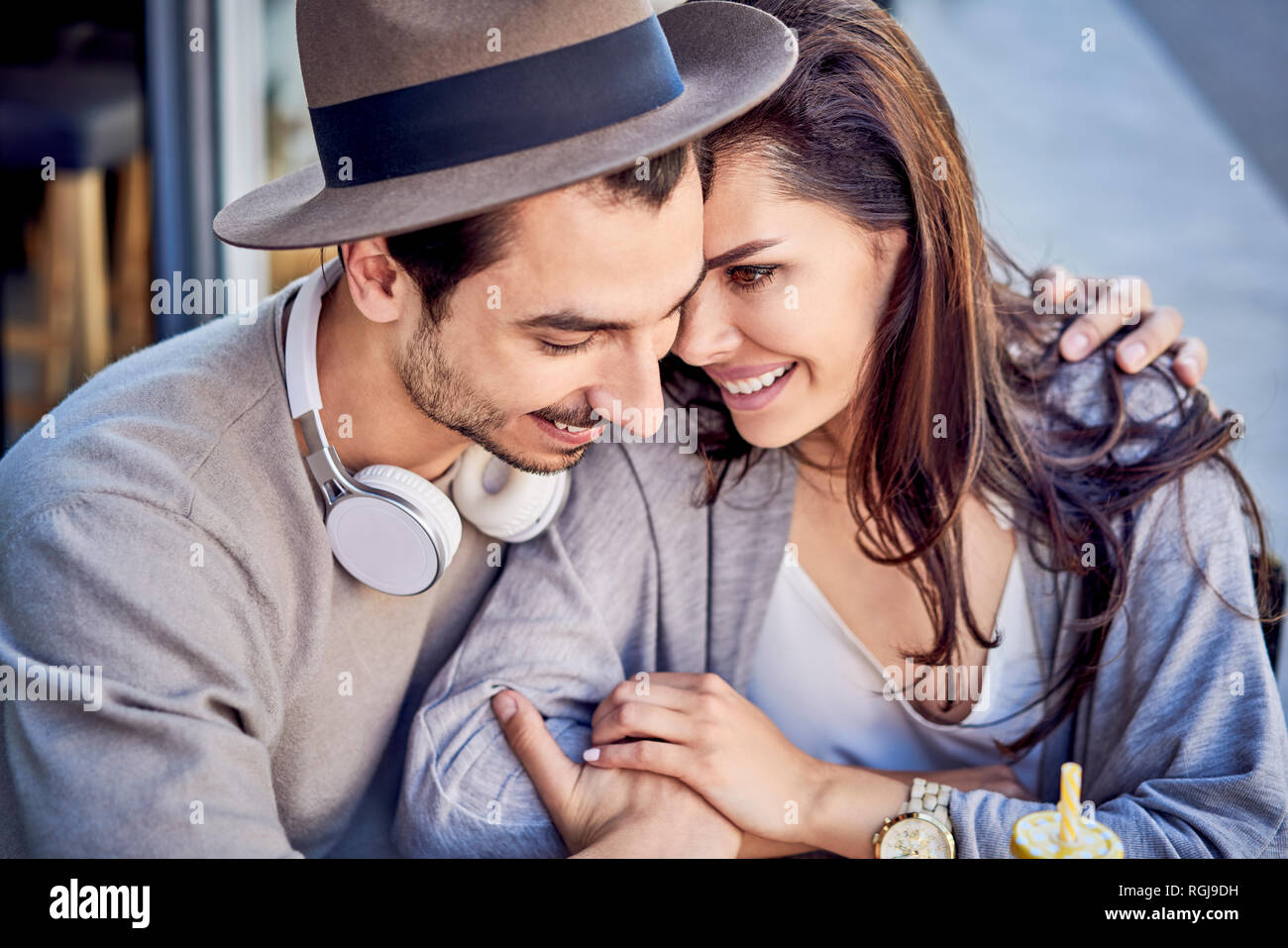 Happy affectionate young couple cuddling outdoors Stock Photo