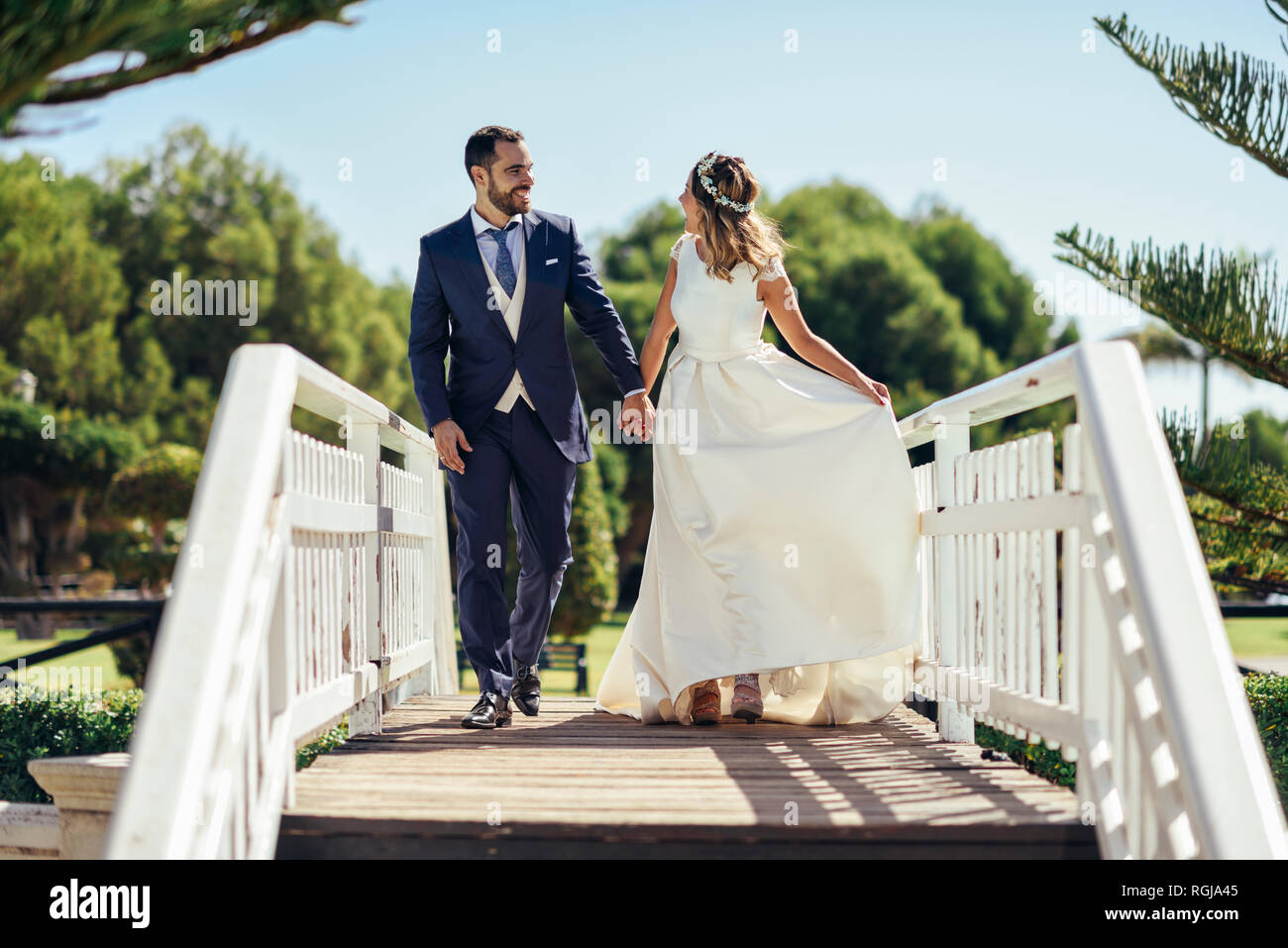 Bridal couple enjoying their wedding day in a park Stock Photo