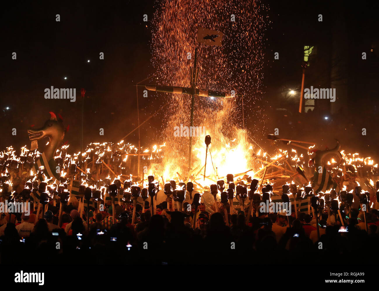 The Galley is set on fire on Shetland Isles during the Up Helly Aa Viking festival. Originating in the 1880s, the festival celebrates Shetland's Norse heritage. Stock Photo