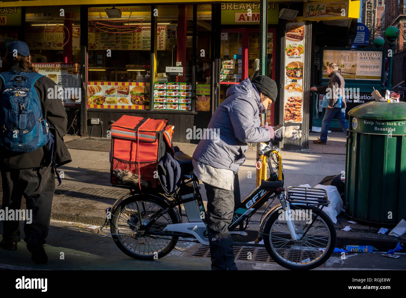 A deliveryman on his Dongguan BuFengZhe (BFZ) electric bike making deliveries in New York in the Chelsea neighborhood on Tuesday, January 22, 2019. (Â© Richard B. Levine) Stock Photo