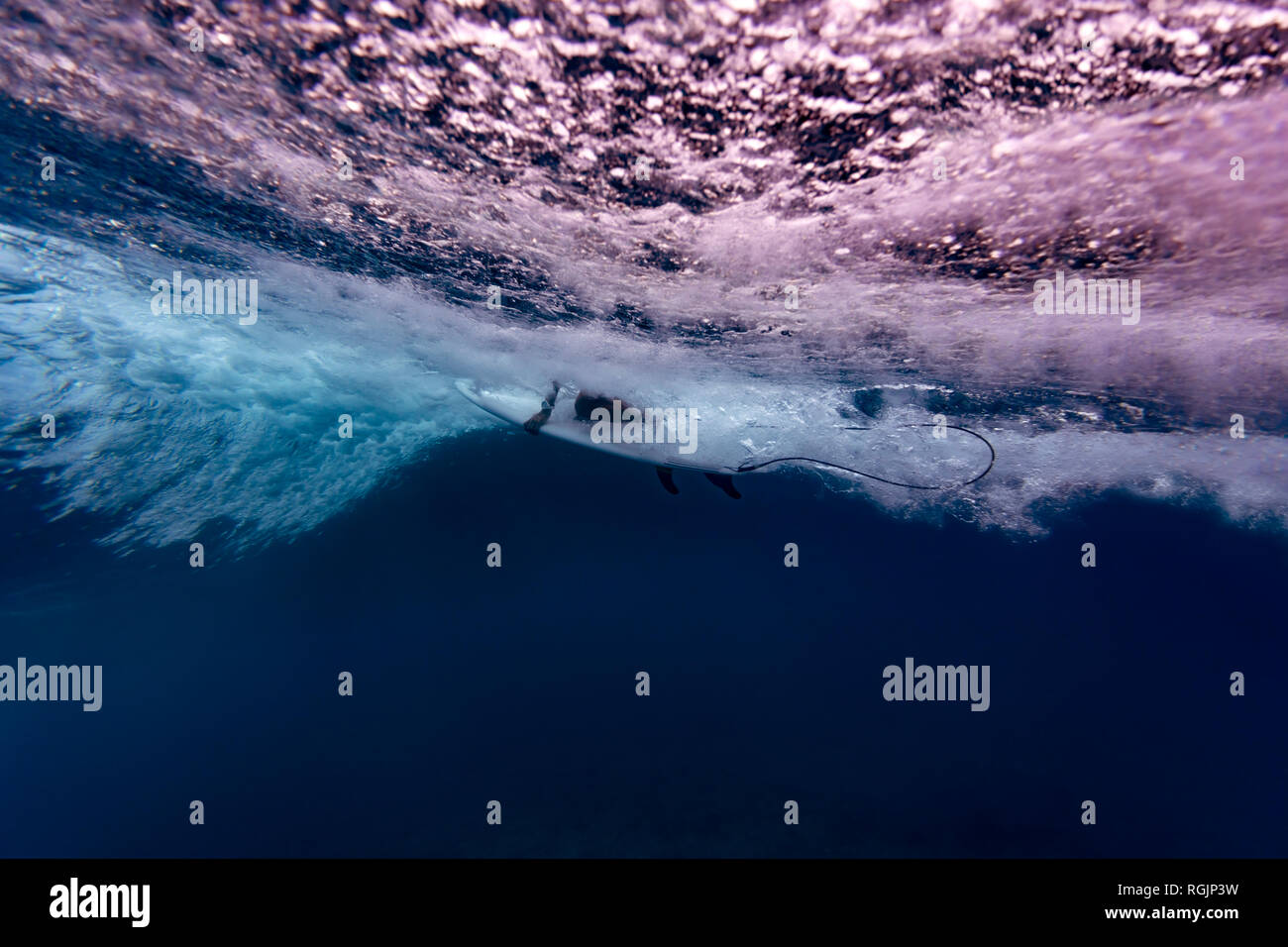 Under water surfers sitting surfboard hires stock photography and