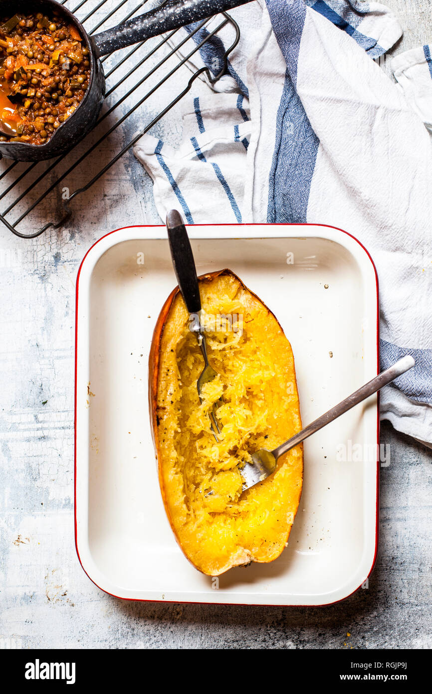 Baked spaghetti squash with vegan bolognese sauce made from lentils, leeks, and carrots Stock Photo