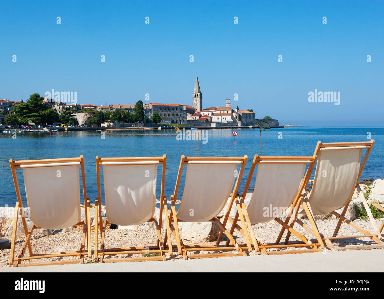 Croatia, Istria, Porec, Old town, Euphrasian Basilica, beach loungers in the foreground Stock Photo