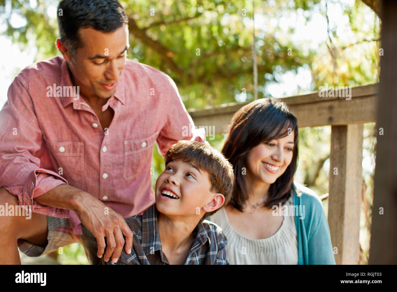 Smiling father and son looking at one another. Stock Photo