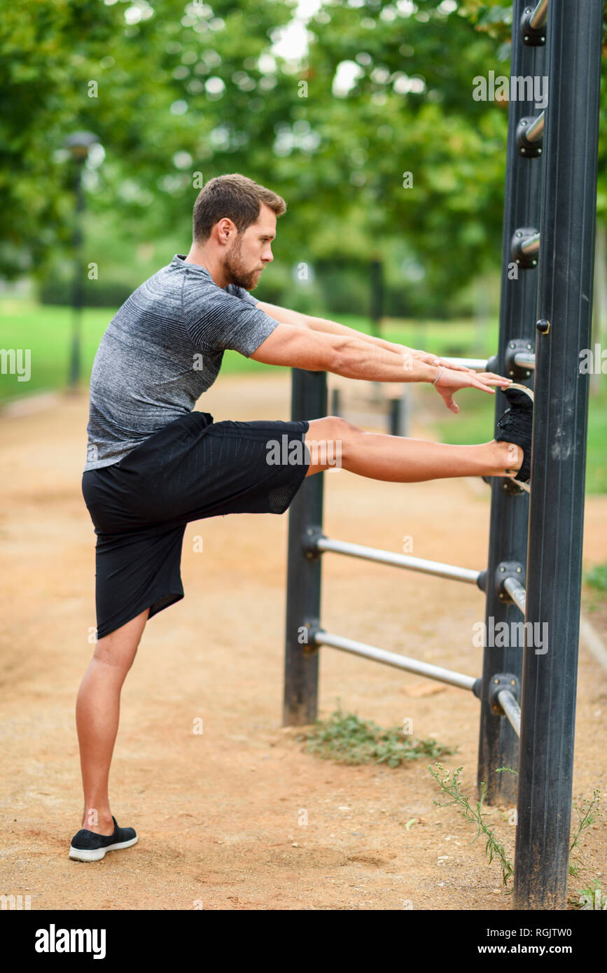 Young athlete douning stretching exercises at a ladder Stock Photo Alamy