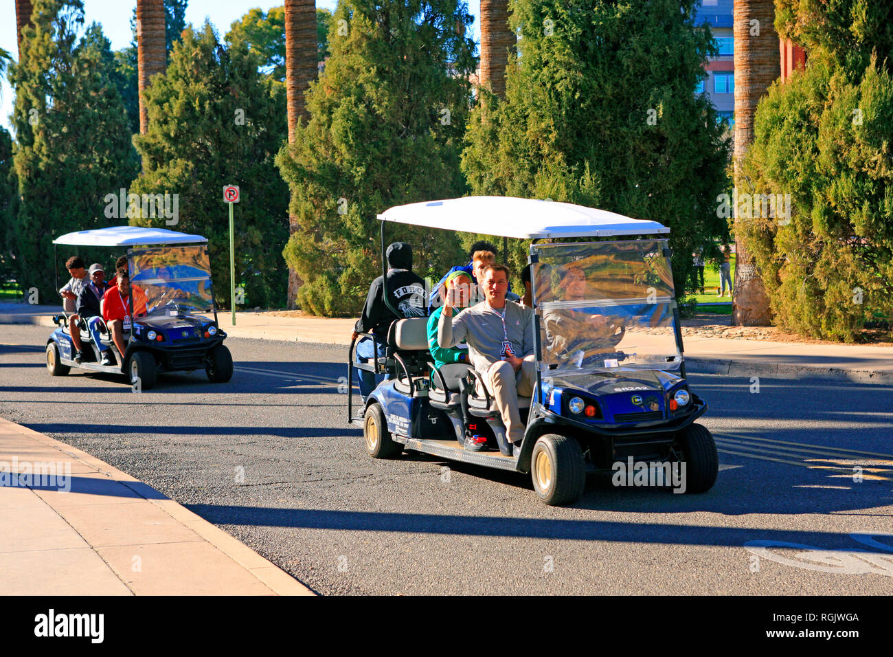 Guest College Football team members getting a guided tour on golf carts
