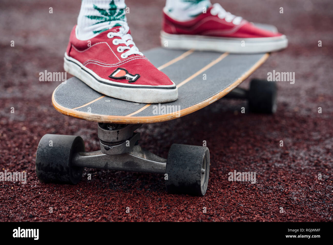 Woman S Feet In Socks And Sneakers On Carver Skateboard Stock