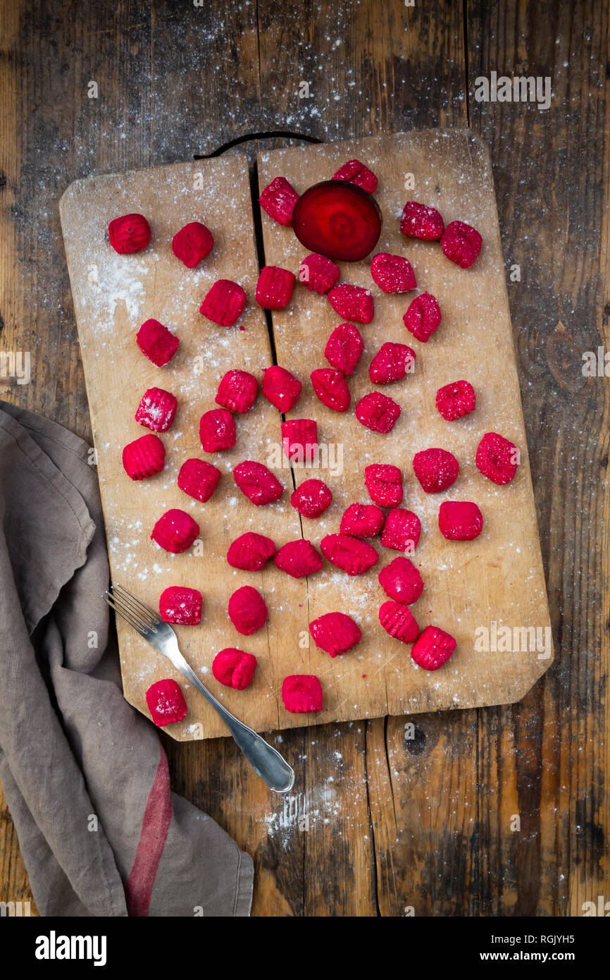 Beetroot gnocchi on chopping board Stock Photo