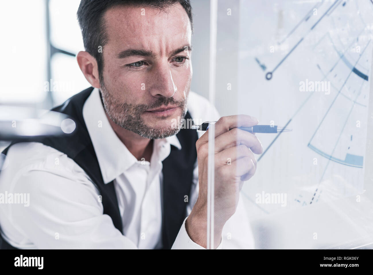Businessman working in office, using futuristic computer with a transperant screen Stock Photo