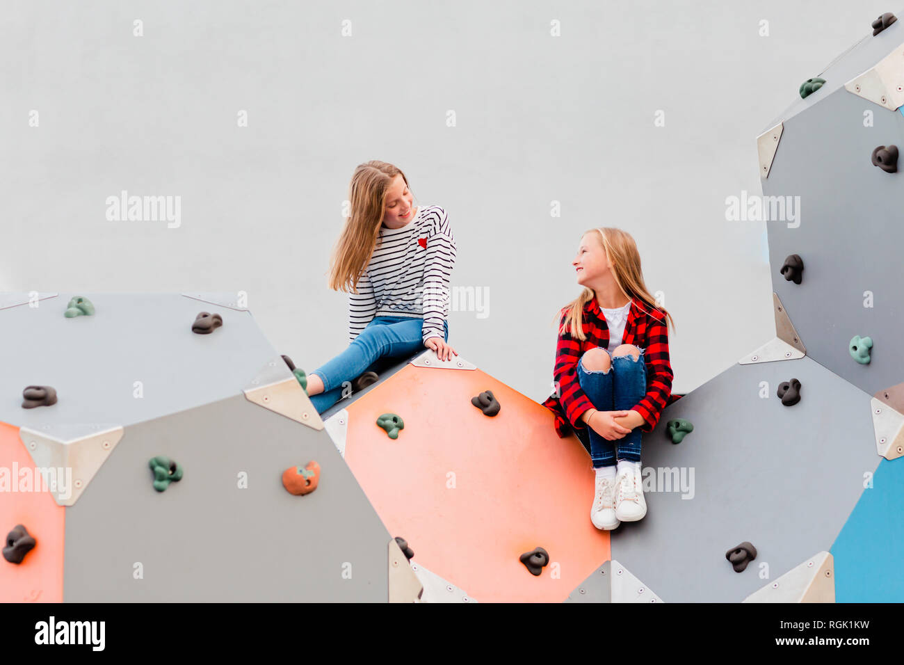 Two smiling girls in climbing gym Stock Photo