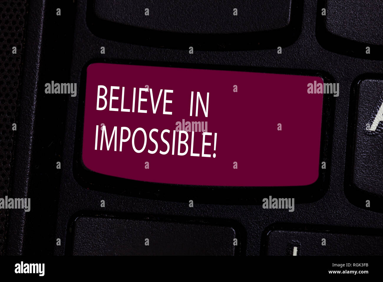 Handwriting text Believe In Impossible. Concept meaning Never give up hope that something amazing will happen Keyboard key Intention to create compute Stock Photo