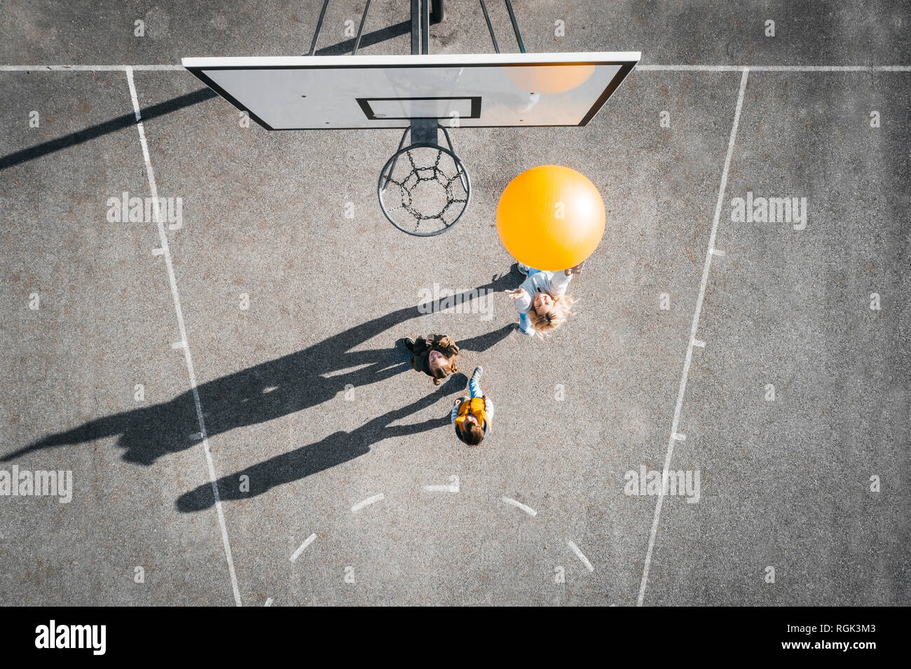 Austria, Aerial view of basketball field, mother and children playing