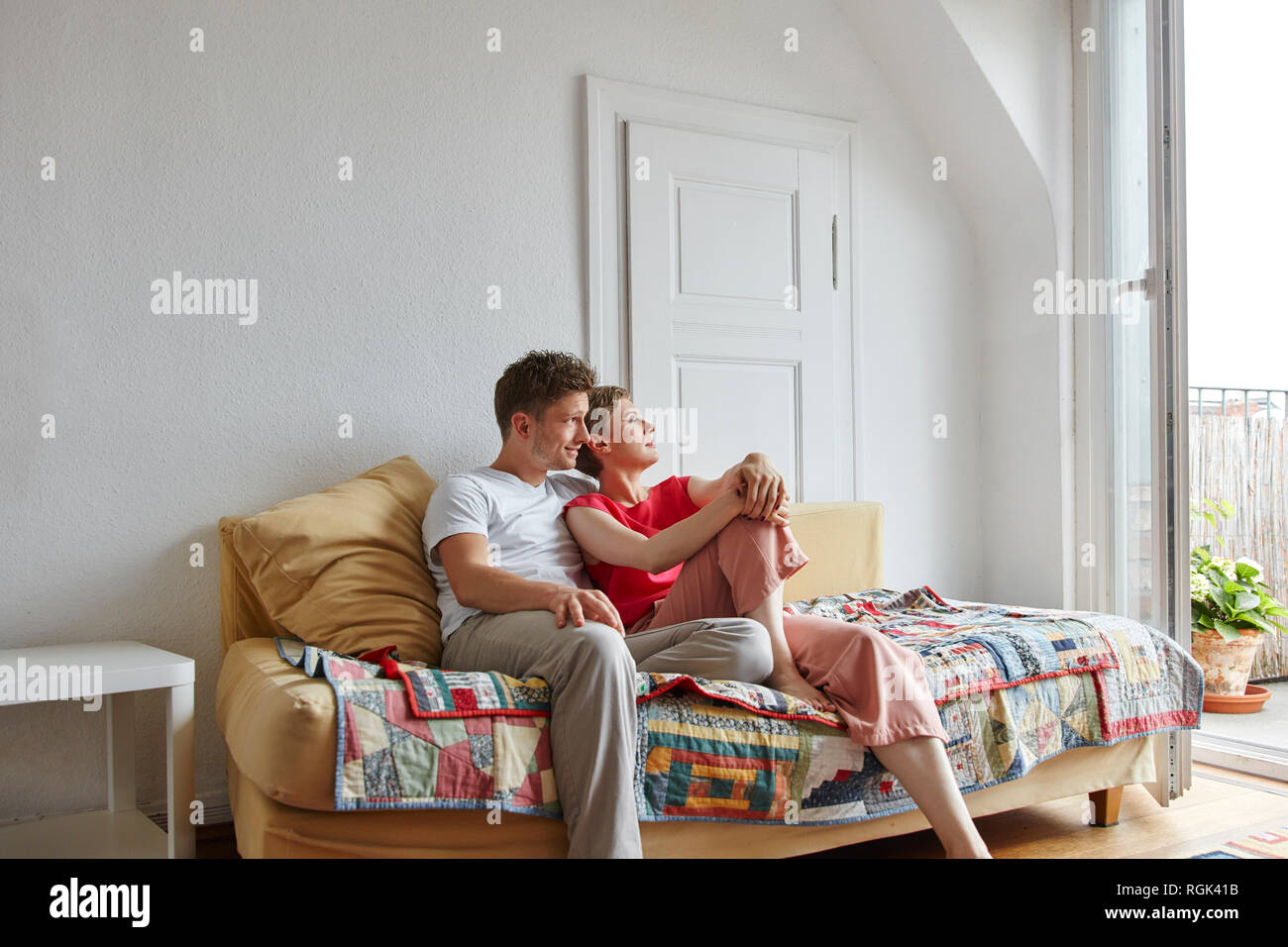 Relaxed couple sitting on couch at home Stock Photo