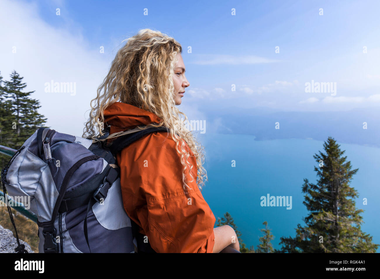 Young woman hiking in the Bavarian mountains, looking at Lake Walchensee Stock Photo