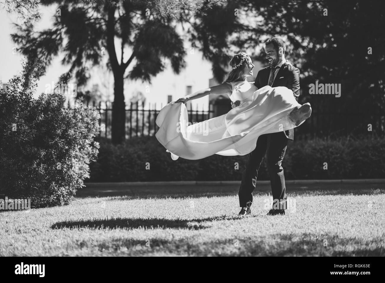 Bridal couple enjoying wedding day in a park Stock Photo