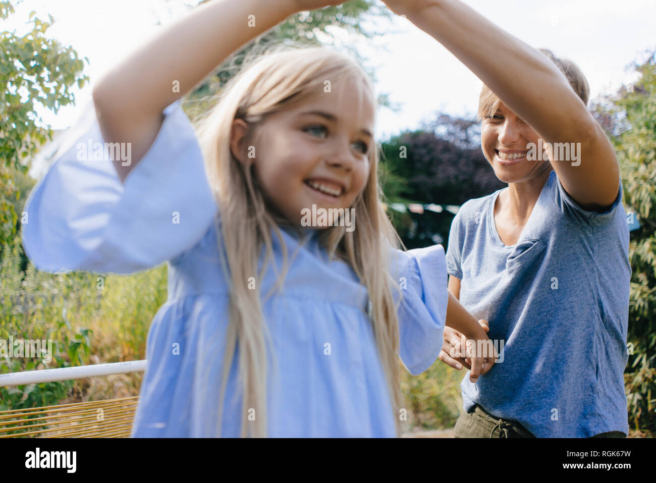 Mother and daughter having fun in garden Stock Photo