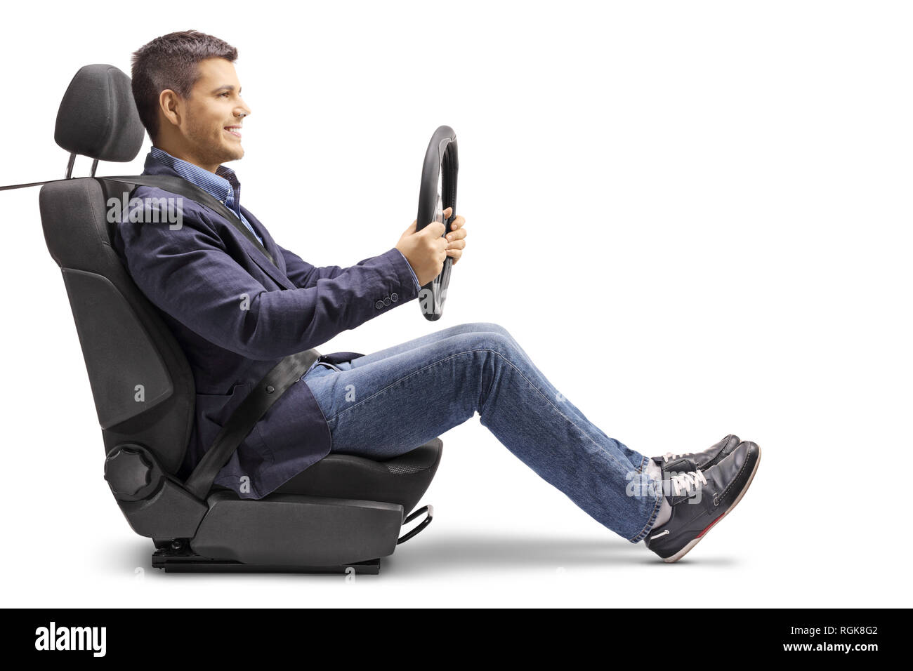Full length profile shot of a young man in a car seat with a fastened