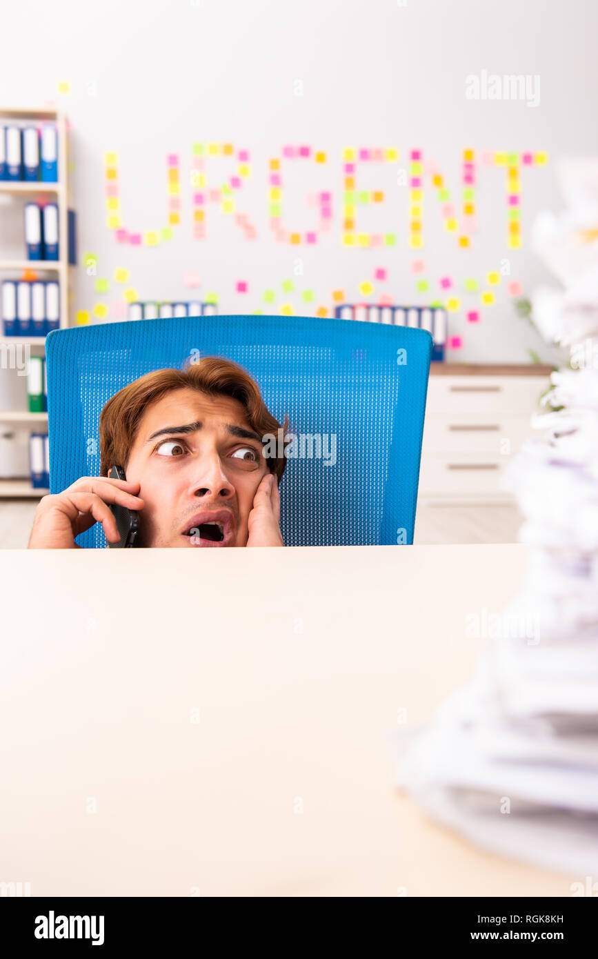 Young employee suffering from excessive work Stock Photo