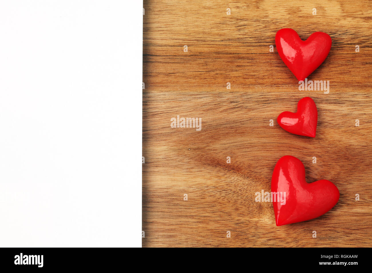 Shiny red hearts on wooden background with empty card Stock Photo - Alamy
