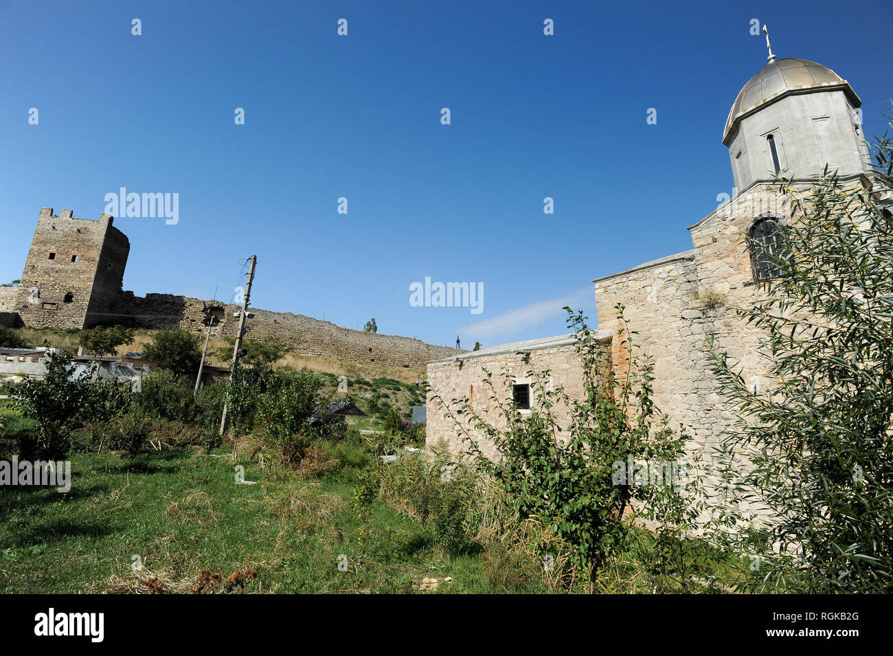 Genoese castle Caffa from XIV century and The Church of the Iveron icon of the Mother of God (former St. John the Baptist armenian church) built in XI Stock Photo
